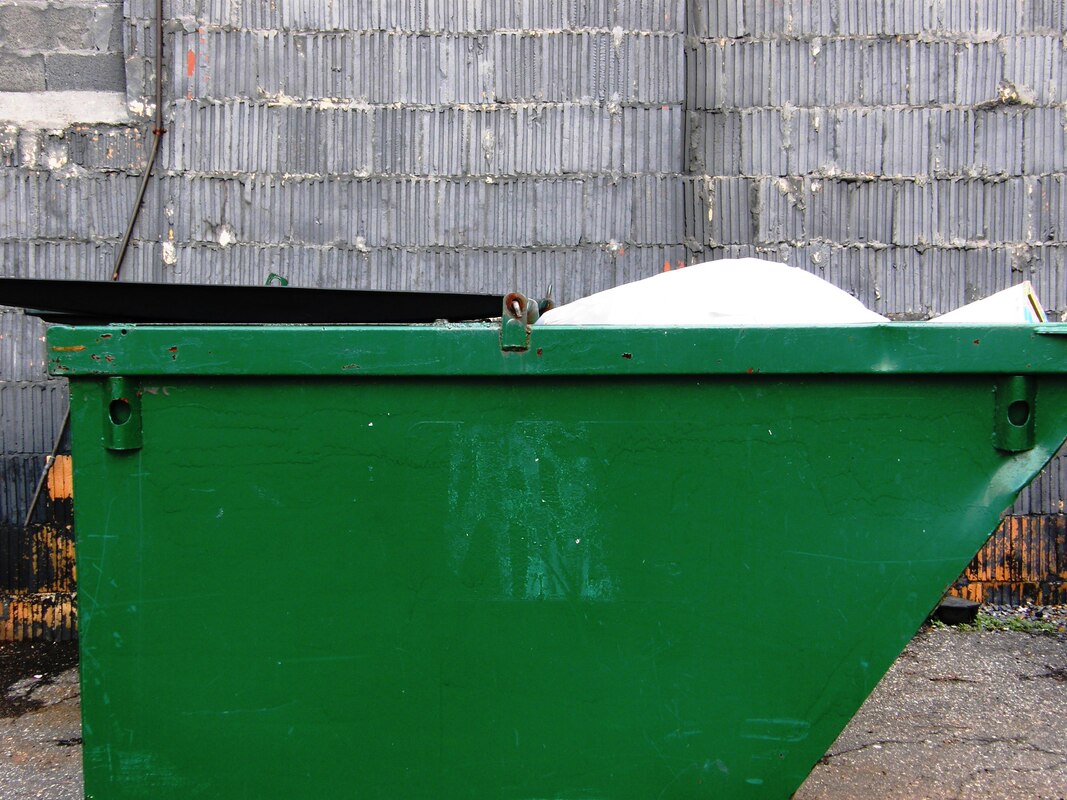 A small 12 yard green residential dumpster